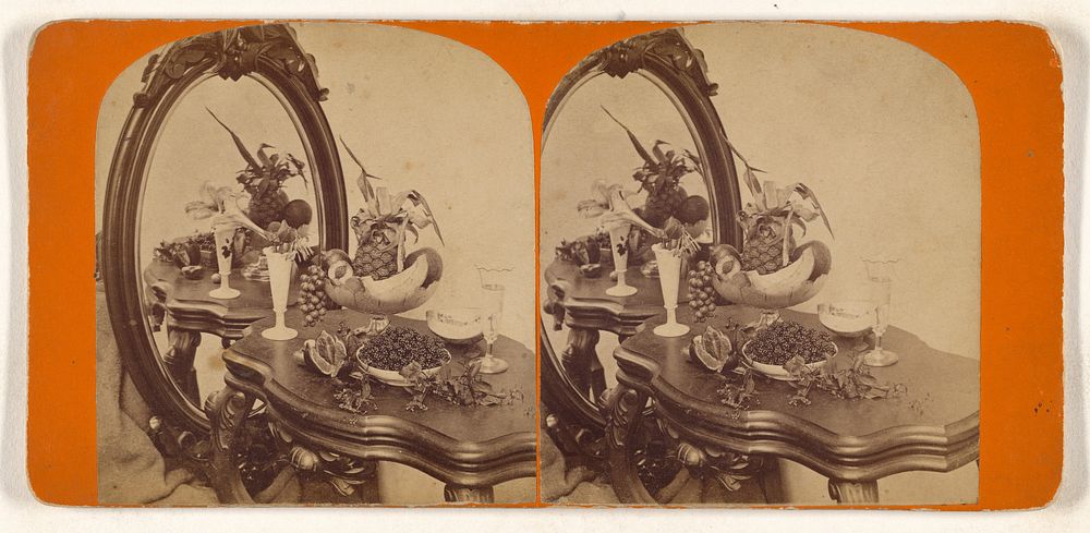 Bowls of fruit, vase of flowers, on table with mirror