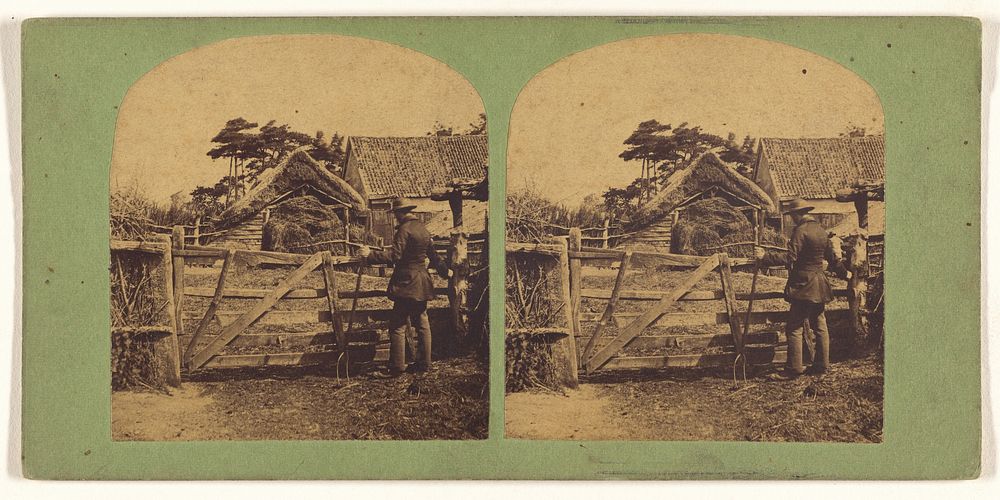 Man holding a pitchfork at gate of French farm