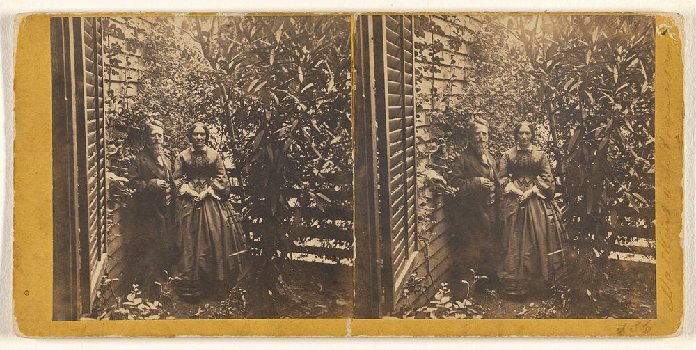 Older couple posed by side of a house with much foliage by Carleton Watkins
