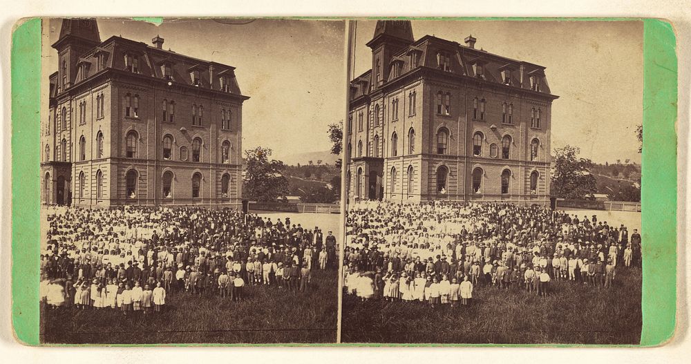 School children posed in yard with large school or another type of building in background, Hoosac Valley, North Adams, Mass.…