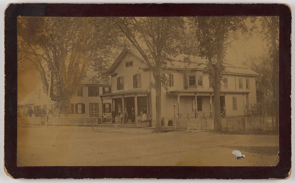 Long view of house with family on front porch by Know