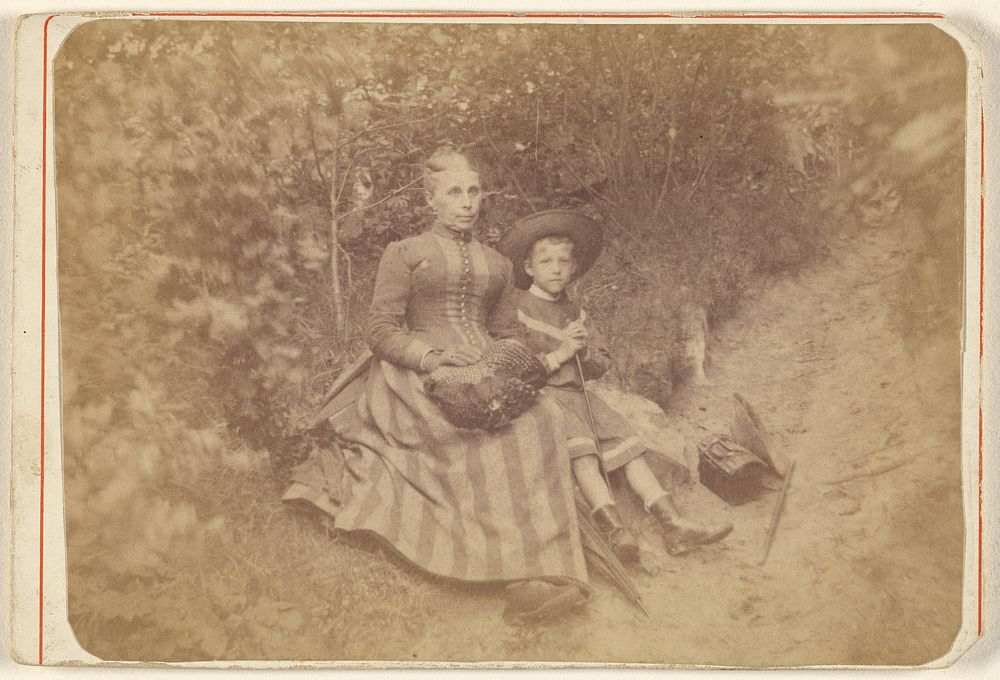 Woman seated on the ground with an boy 