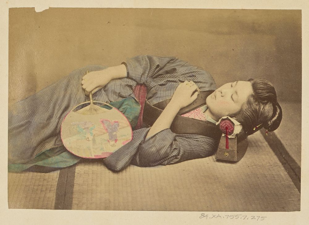 Sleeping Japanese woman holding a fan by Felice Beato and Baron Raimund von Stillfried