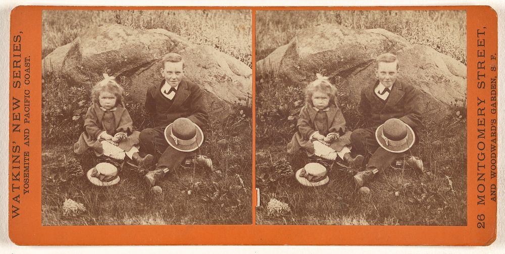 Unidentified girl and boy seated on grass in front of large rock by Carleton Watkins