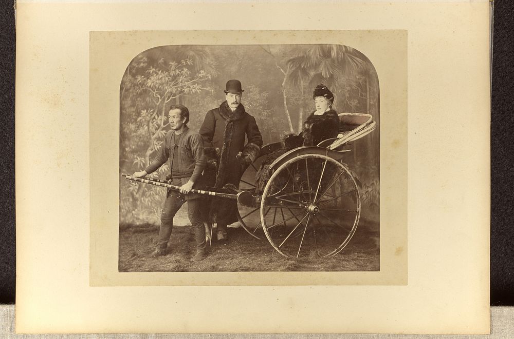 Studio portrait of a European couple posing with an Asian rickshaw puller