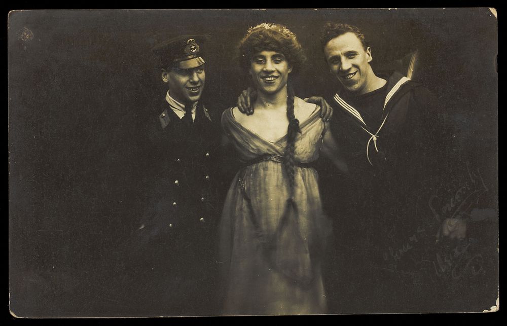 Three sailors with arms round each other. Photographic postcard, 1917.