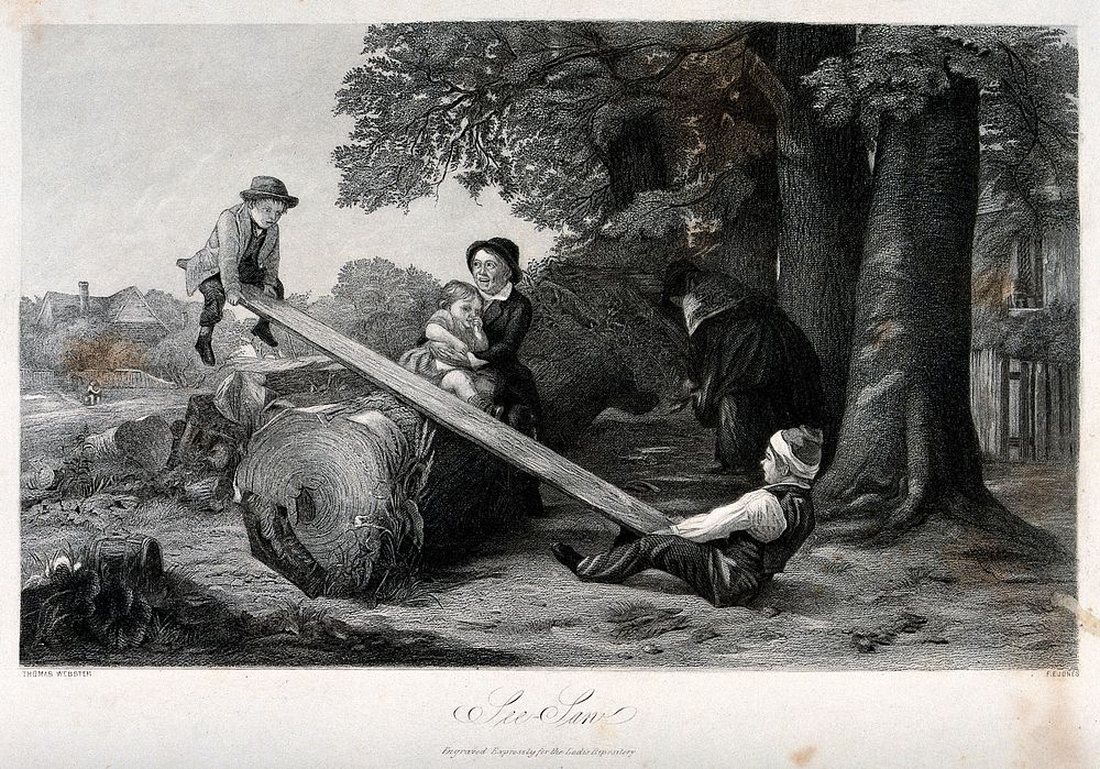 Two boys use a plank of wood over a log as a see-saw, one woman sits with a chid on the log and another stands nearby.…