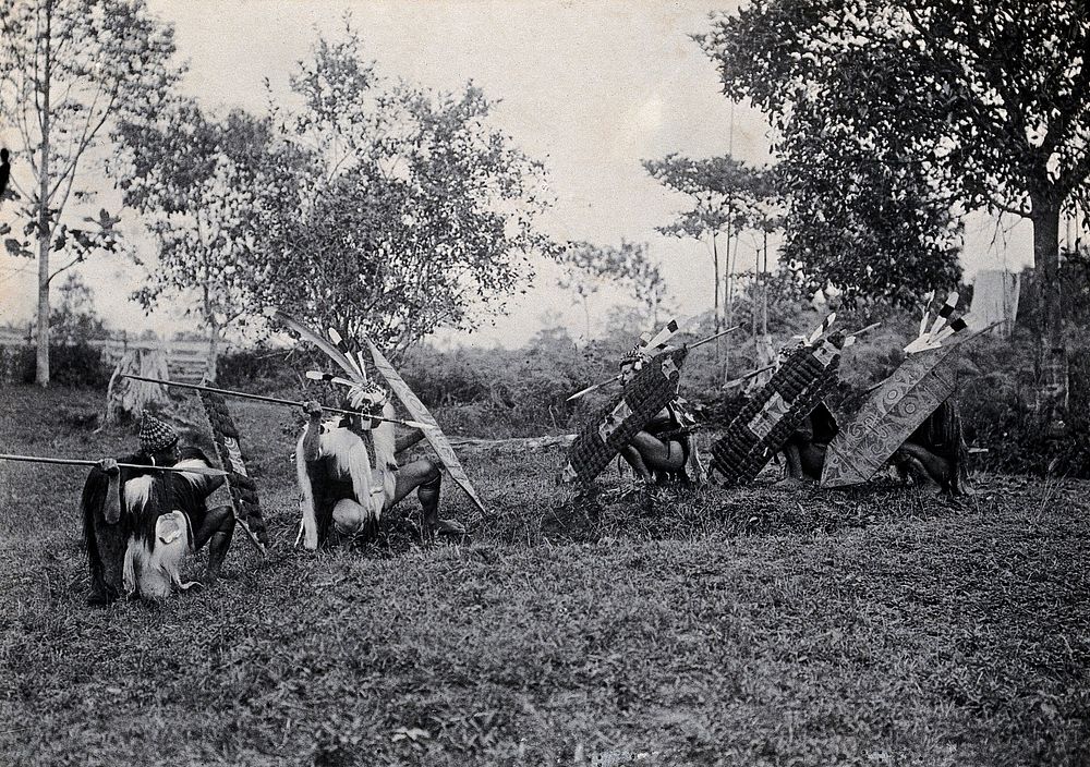 Sarawak: five Kenyah warriors in a warfare ritual. Photograph.