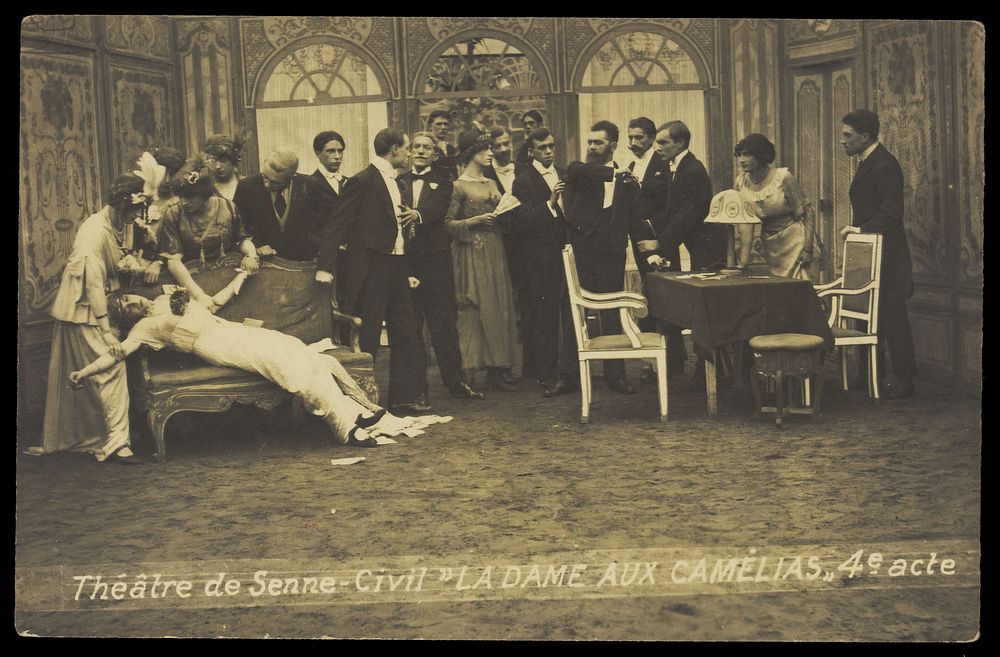 French or Belgian prisoners of war, some in drag, posing on stage during a crowded scene of "La dame aux camélias"; at…