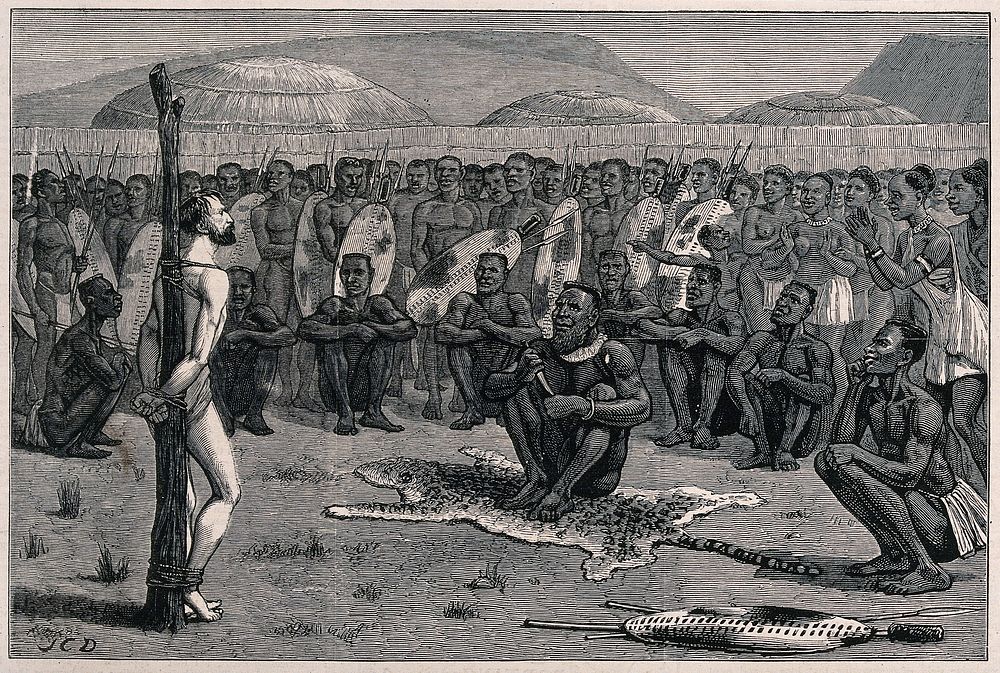 Ernest Grandier, a prisoner of the Zulus, stands naked and tied to a post before the tribe awaiting judgement from the chief…