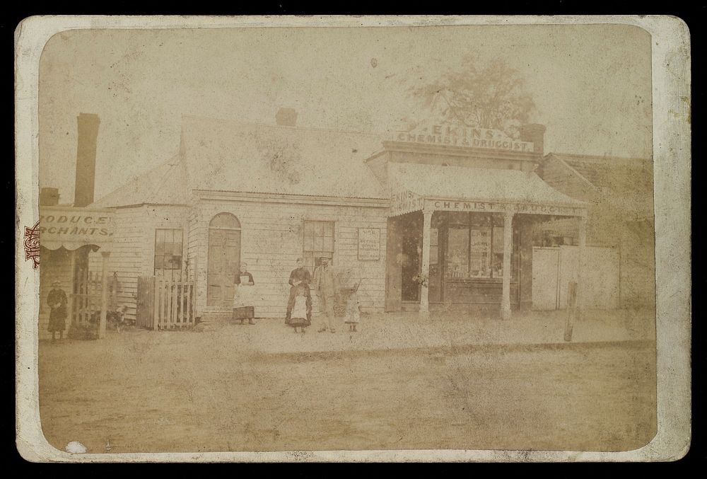 Ekins pharmacy, Melbourne, Victoria: the shop seen from the street, with the pharmacist and his family standing outside.…