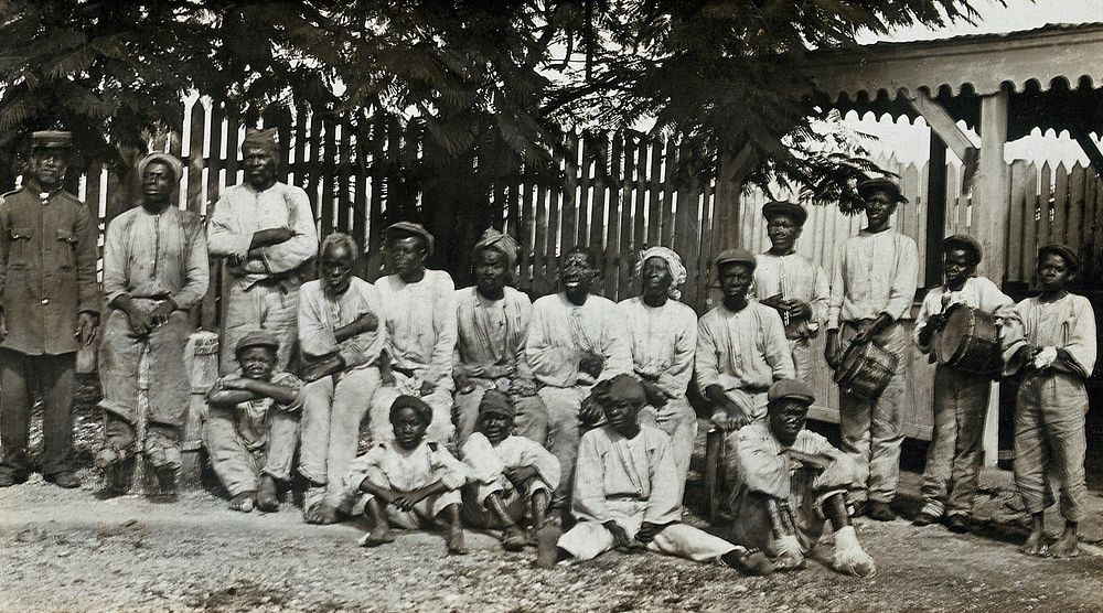 Leper asylum, Rat Island, Antigua: a group of male patients, some with musical instruments. Photograph, 1890/1910.