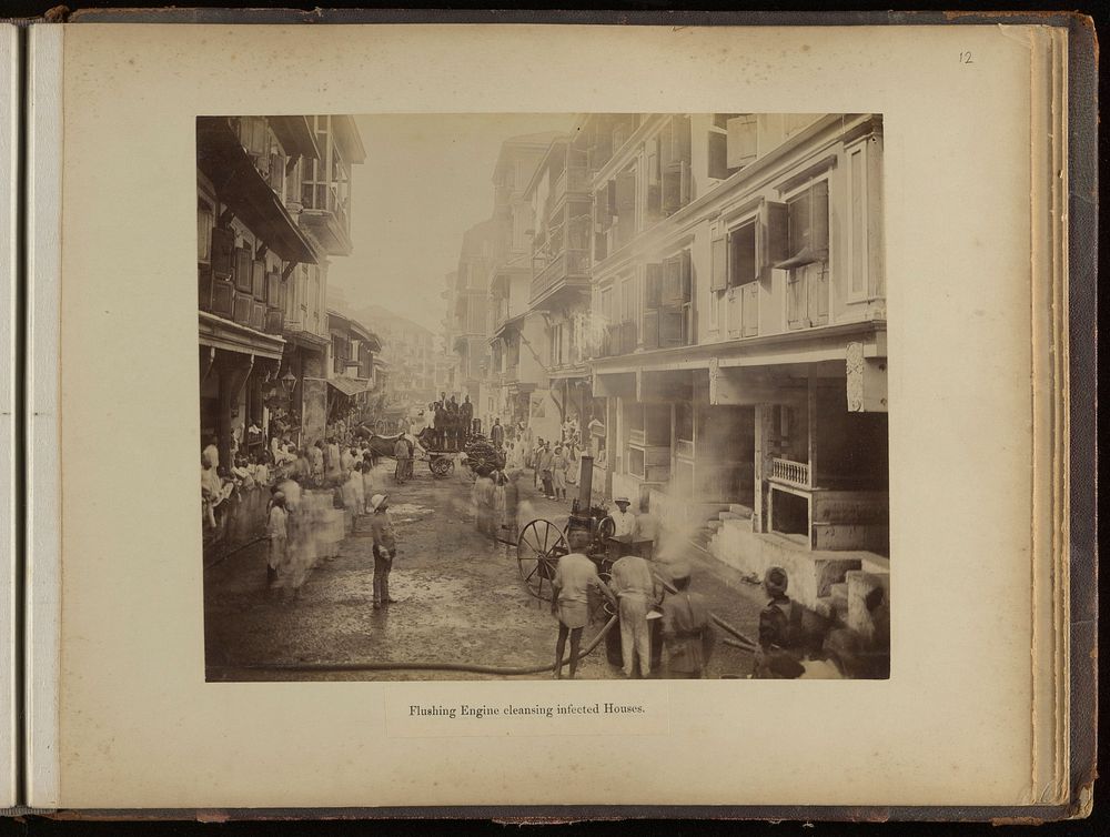 Groups of men on a street spraying jets of water into plague infected houses, during the epidemic of plague in Bombay.…
