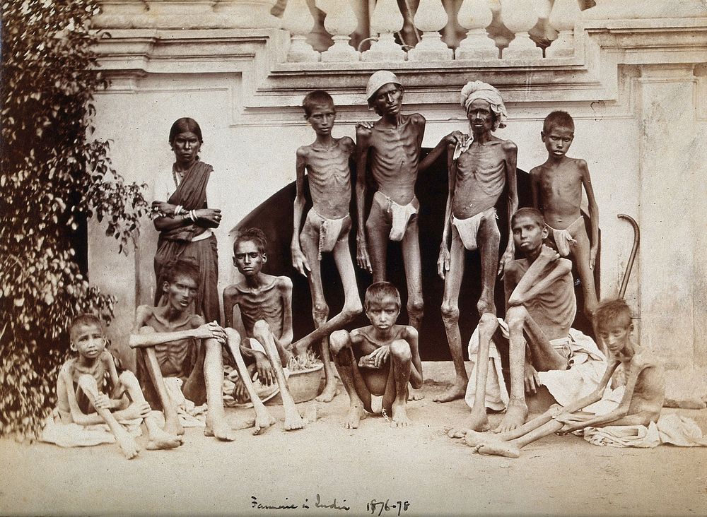 Famine in India: emaciated young men wearing loin cloths and a woman wearing a sari. Photograph attributed to Willoughby…