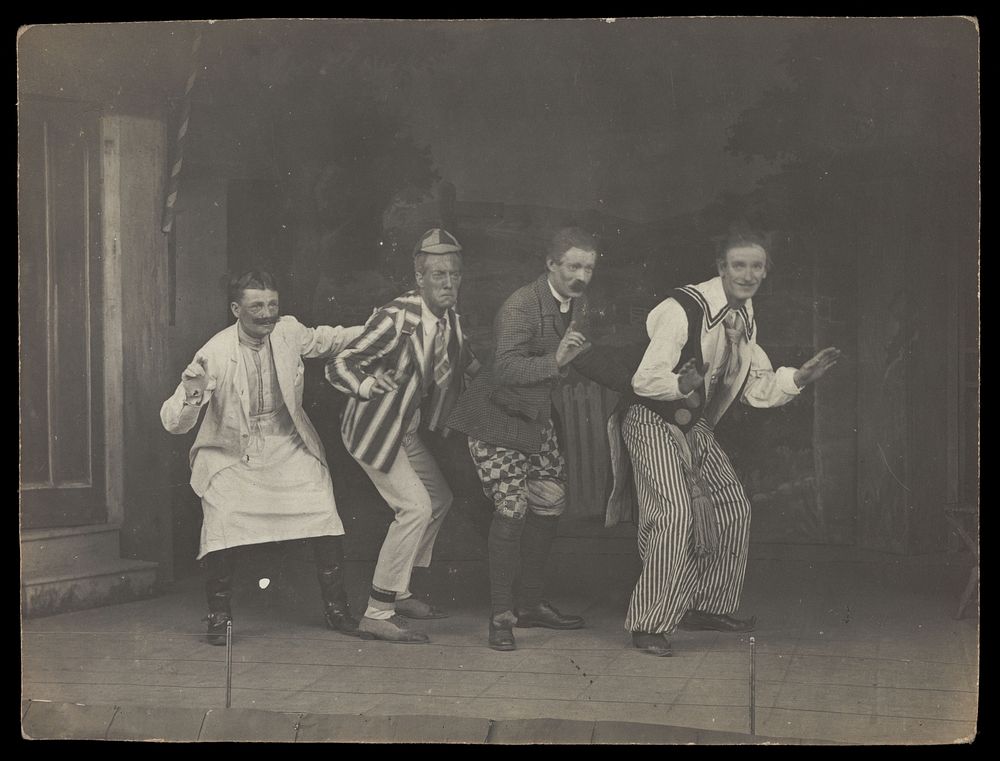 Sailors on stage in mid-pose, wearing a variety of costumes. Photographic postcard, 191-.