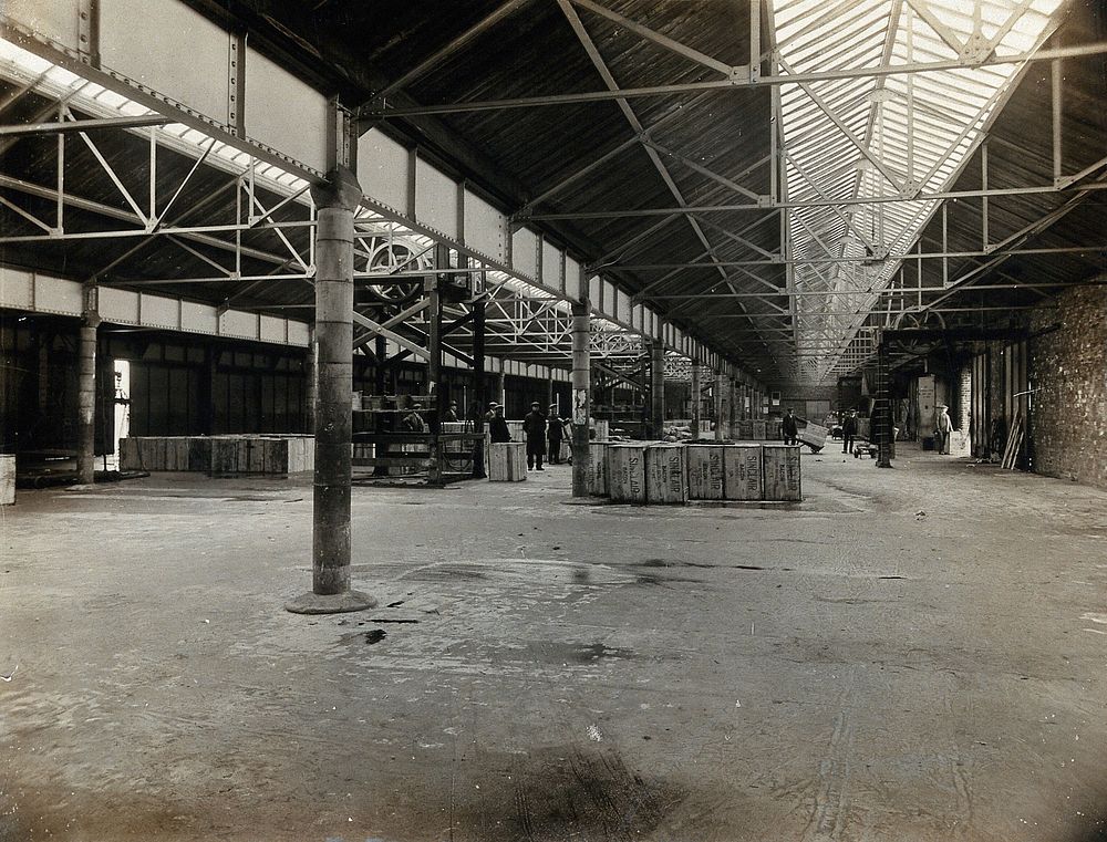 Liverpool, England: a large shed at the port: interior showing staff with boxes. Photograph, 1900/1920.