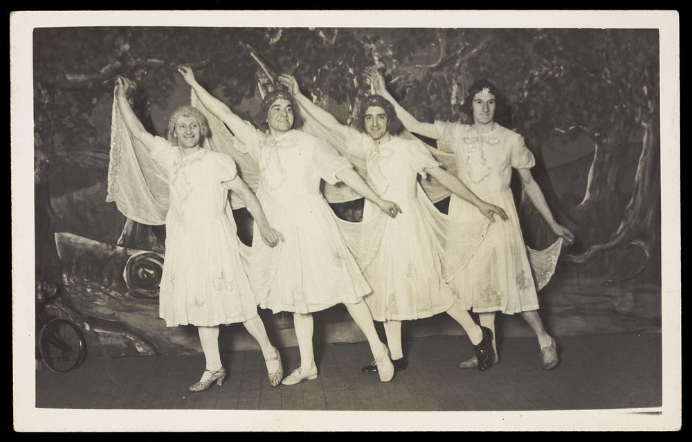 Amateur actors in drag, wearing white dresses and dancing on stage. Photographic postcard, 191-.