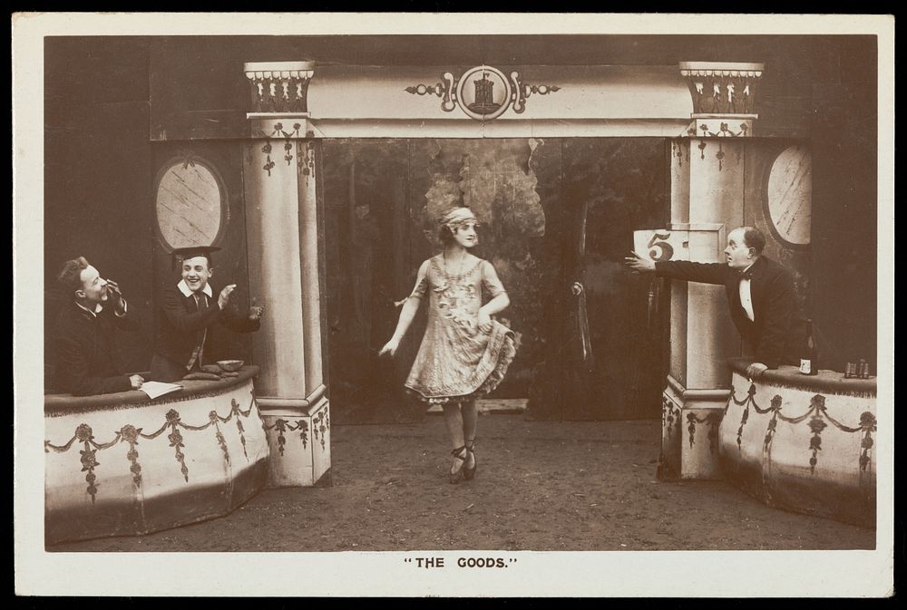 Soldiers, one in drag, performing in the concert party "The Goods". Photographic postcard, 1918.