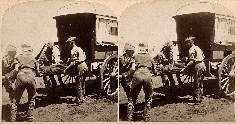 Boer War: a casualty of the Battle of Modder River being loaded onto an ambulance. Photograph by Underwood & Underwood, 1900.