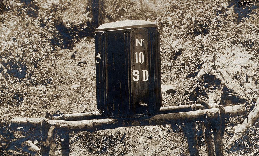 Mosquito repellent oil contained in a drip-barrel. Photograph, 1910.