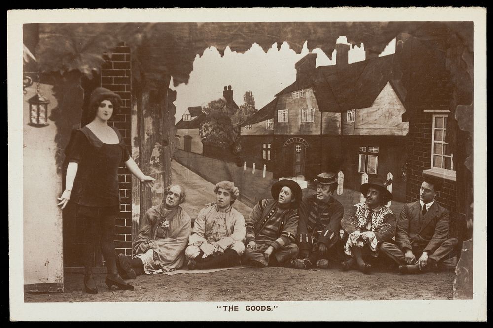 Soldiers, one in drag, performing in the concert party "The Goods". Photographic postcard, 1918.