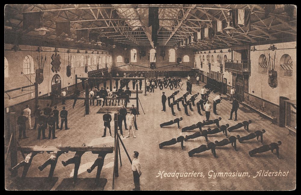 Soldiers performing gymnastic exercises at a military gymnasium in Aldershot. Process print, 190-.
