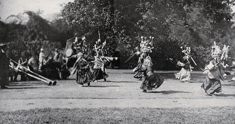 The Maidan park, Calcutta, India: traditional Sikkim Devil dancers performing for King George V and Queen Mary (then the…