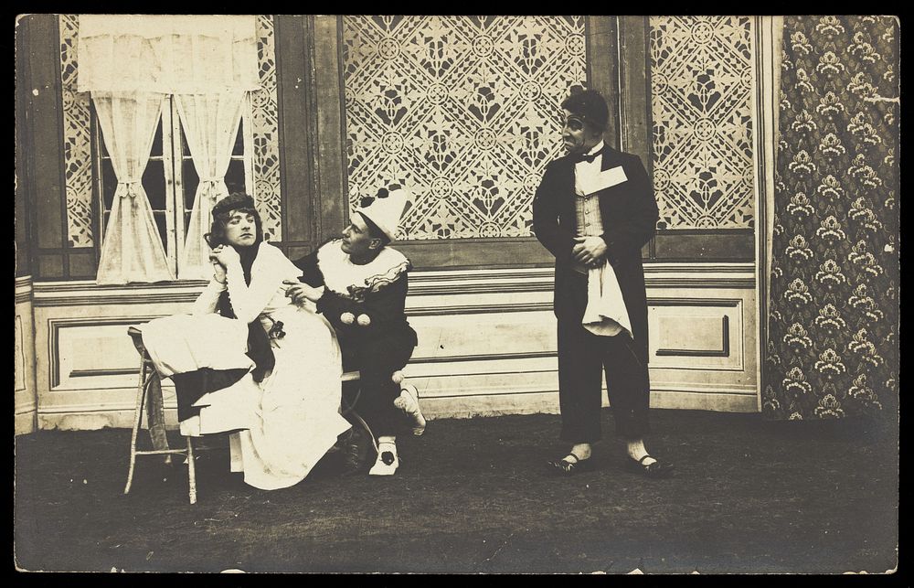 Three men performing a scene from a play. Photographic postcard. 191-.