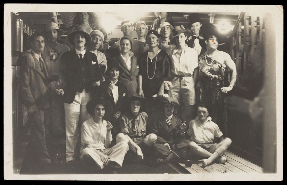 Passengers on RMS Armadale Castle, some in drag, pose for a group portrait. Photographic postcard, 1933.