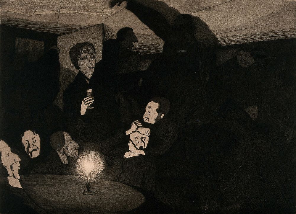 People gathered around a candle-lit table; one man, held by another appears terrified, one person holds a glass, and a large…
