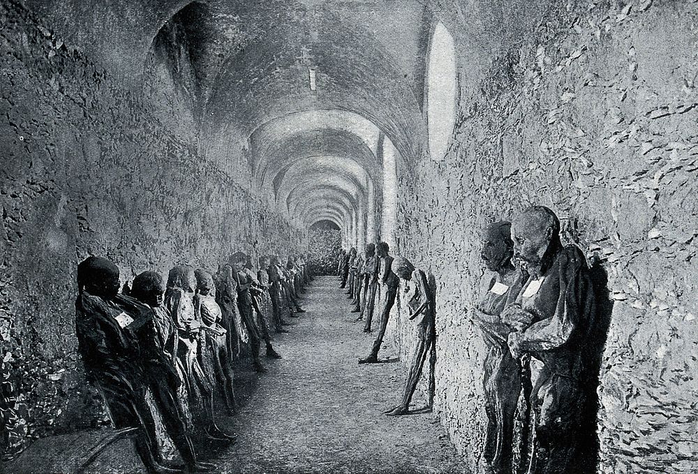 Corpses standing against the walls of catacombs at Guanajuato, Mexico. Process print after C.C. Pierce & Co.