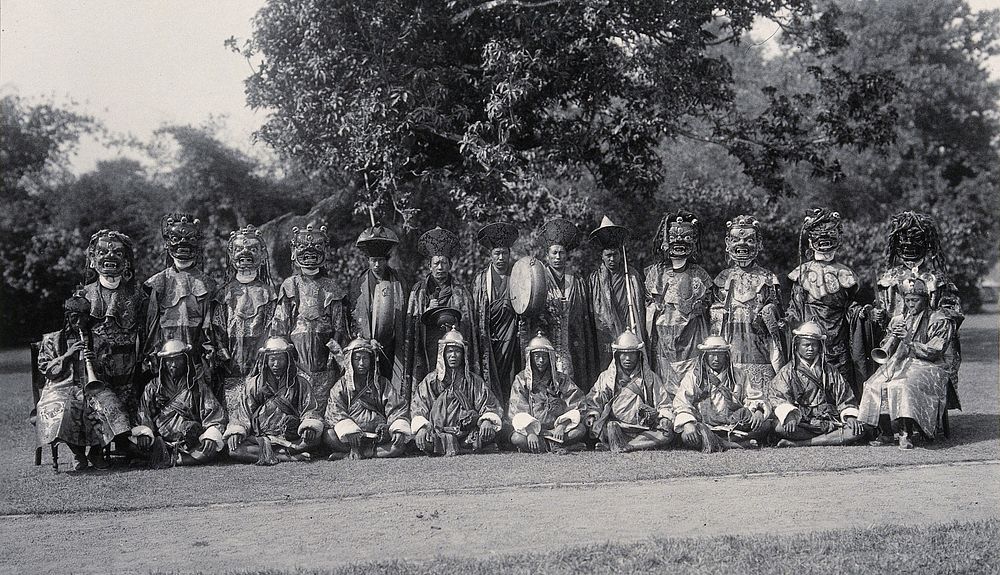 The Maidan park, Calcutta, India: traditional Bhutan Devil dancers, some wearing masks: group portrait. Photograph, 1906.