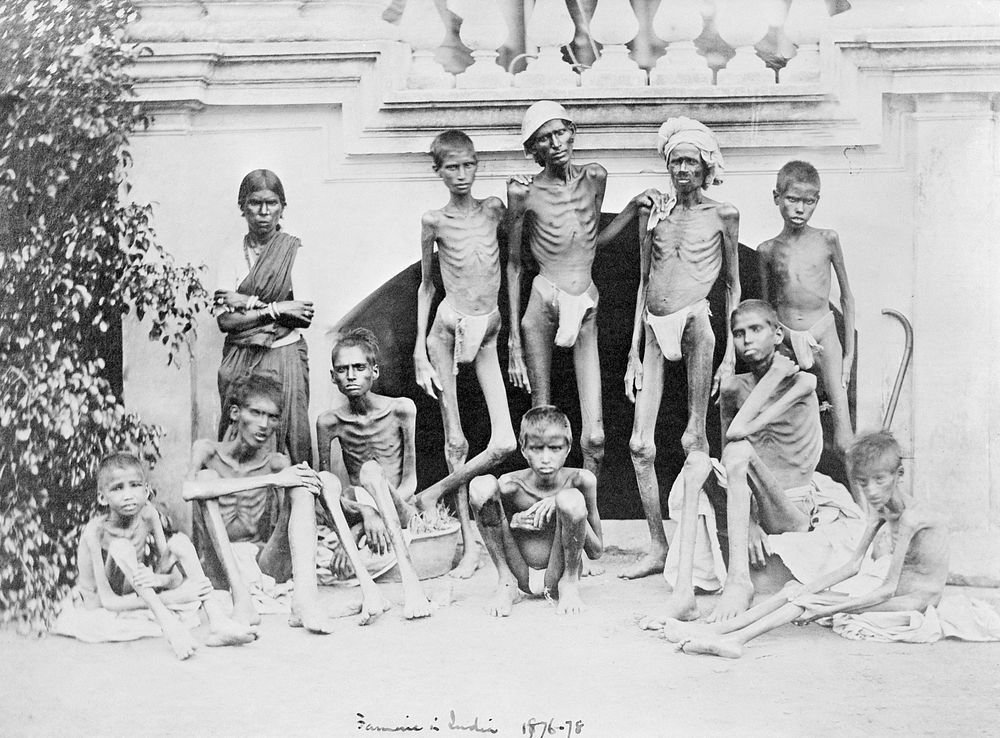 Famine in India: emaciated young men wearing loin cloths and a woman wearing a sari. Photograph attributed to Willoughby…