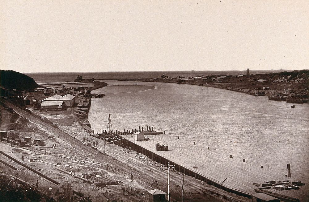 East London, South Africa: a jetty and buildings near the mouth of the Buffalo River. Woodburytype, 1888, after a photograph…