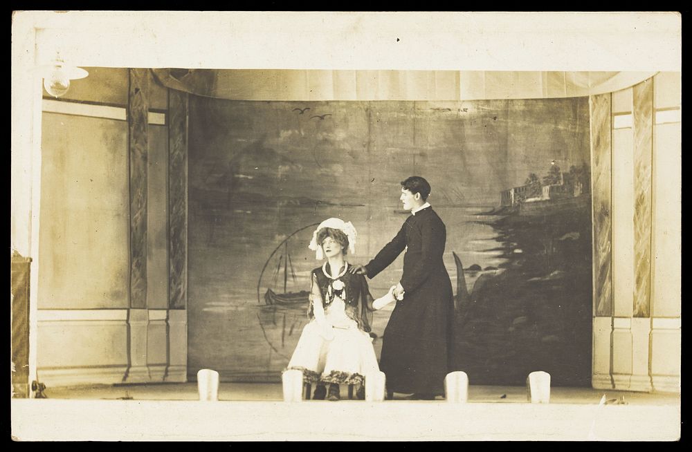 Two men in drag acting on stage. Photographic postcard. 1905-1910.