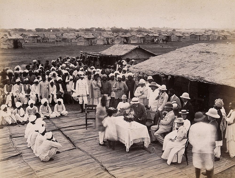 Discharged hospital patients after bubonic plague outbreak, being given relief money, Karachi, India. Photograph, 1897.