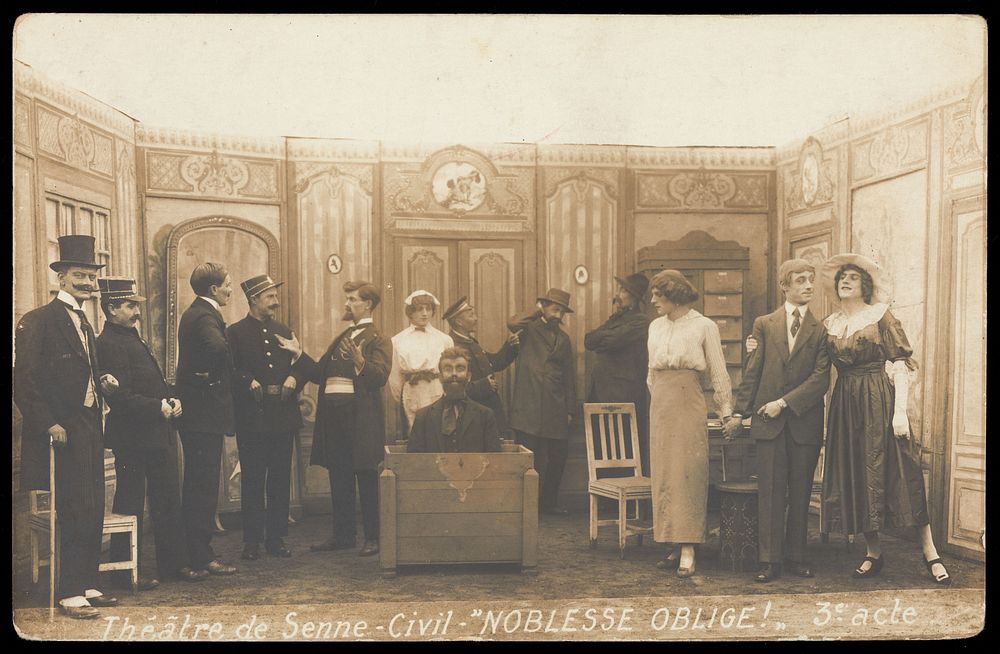 Prisoners of war, some in drag, posing on stage during a crowded scene of "Noblesse oblige"; at Sennelager prisoner of war…
