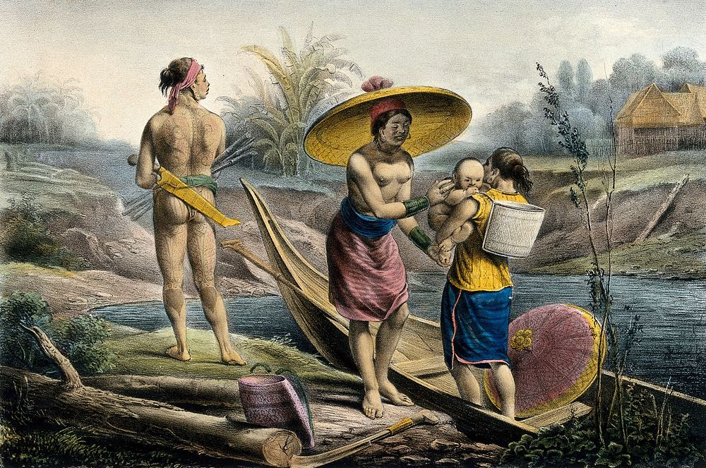 A Dyak woman in a canoe is handing her child to a woman on the river bank; a tattooed man is holding various objects.…