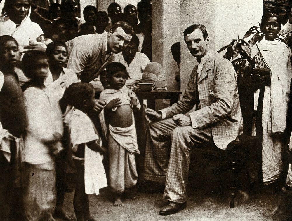 Inoculation against cholera: two men in suits prepare to inoculate a child, surrounded by a crowd of (Indian ) parents and…