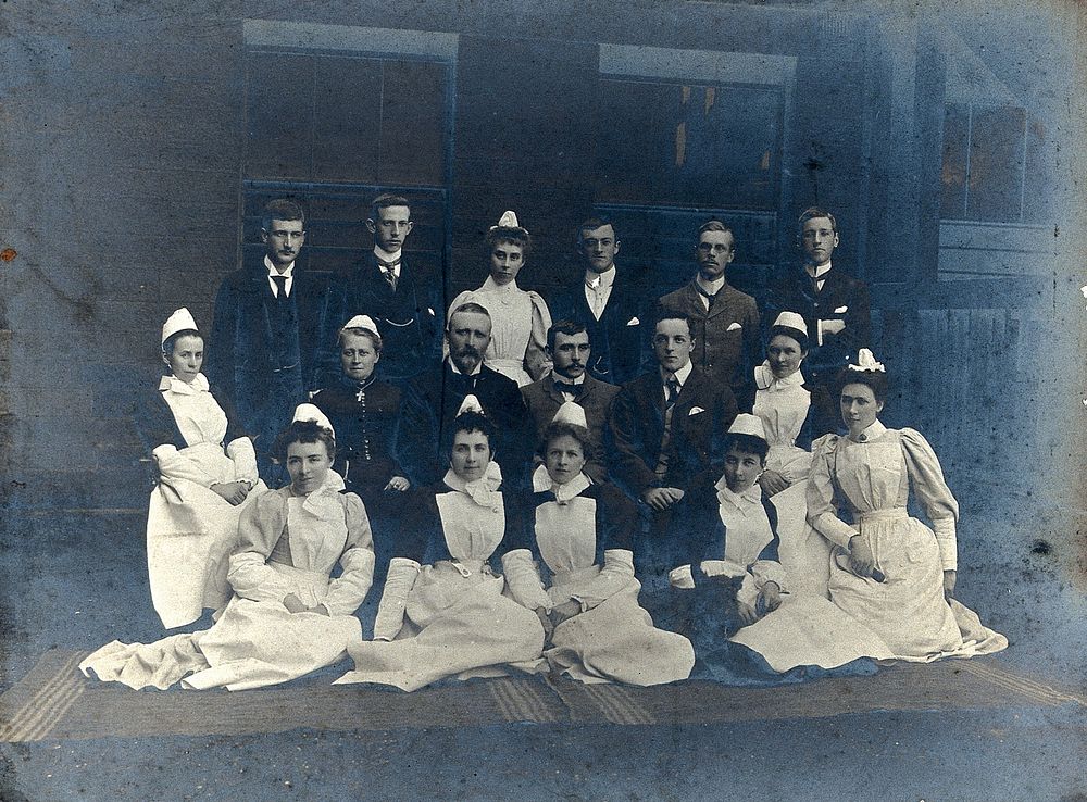 James Rutherford Morison with his staff: seven men and nine women. Photograph, ca. 1900.