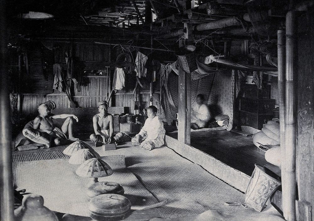 Sarawak: interior of a Kadayan tribal house, with a meal laid out. Photograph.