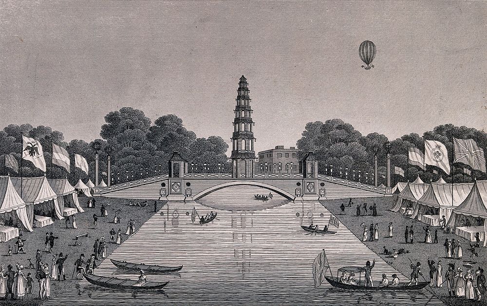 St. James's Park: people boating on the lake which has marquees with flags flying on its banks, a hot-air balloon flies…