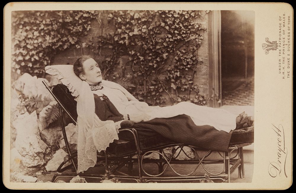 An invalid lady reclining outdoors on a chaise longue. Photograph by J.A. Draycott, 189-.