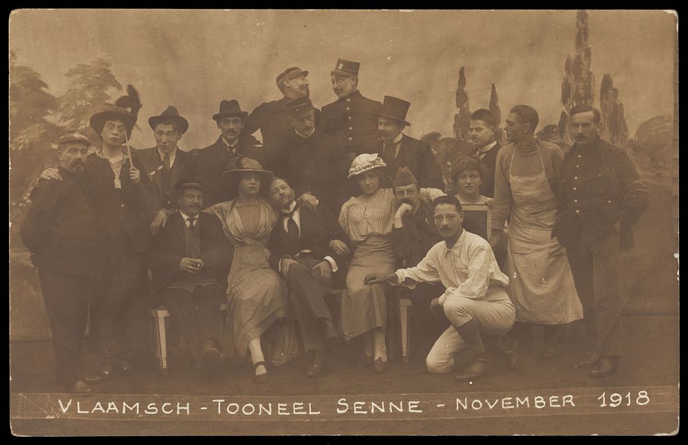 Belgian prisoners of war, some in drag, pose on stage for a group portrait; at Sennelager prisoner of war camp in Germany.…