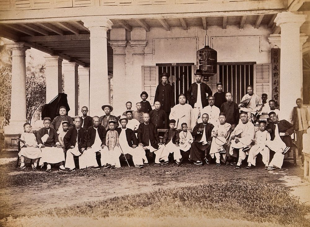 Malaya: Chinese merchants grouped outside their club house on Penang Island. Photograph by J. Taylor, 1881.