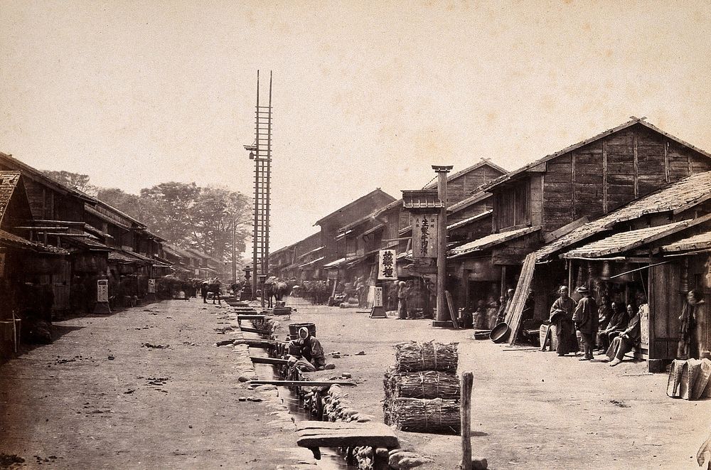 Atsunghi, Japan: the main street lined with wooden houses. Photograph by Felice Beato, ca. 1868.