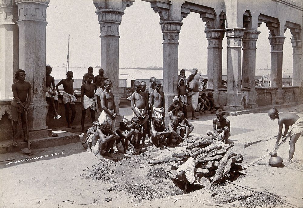 A burning ghat, Kolkata, India: mourners by the funeral pyre. Photograph, ca. 1890.