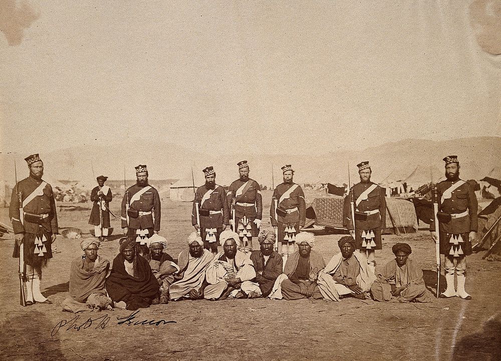 Scottish  soldiers with Indian men at a military encampment (during the Second China War). Photograph, ca. 1860.