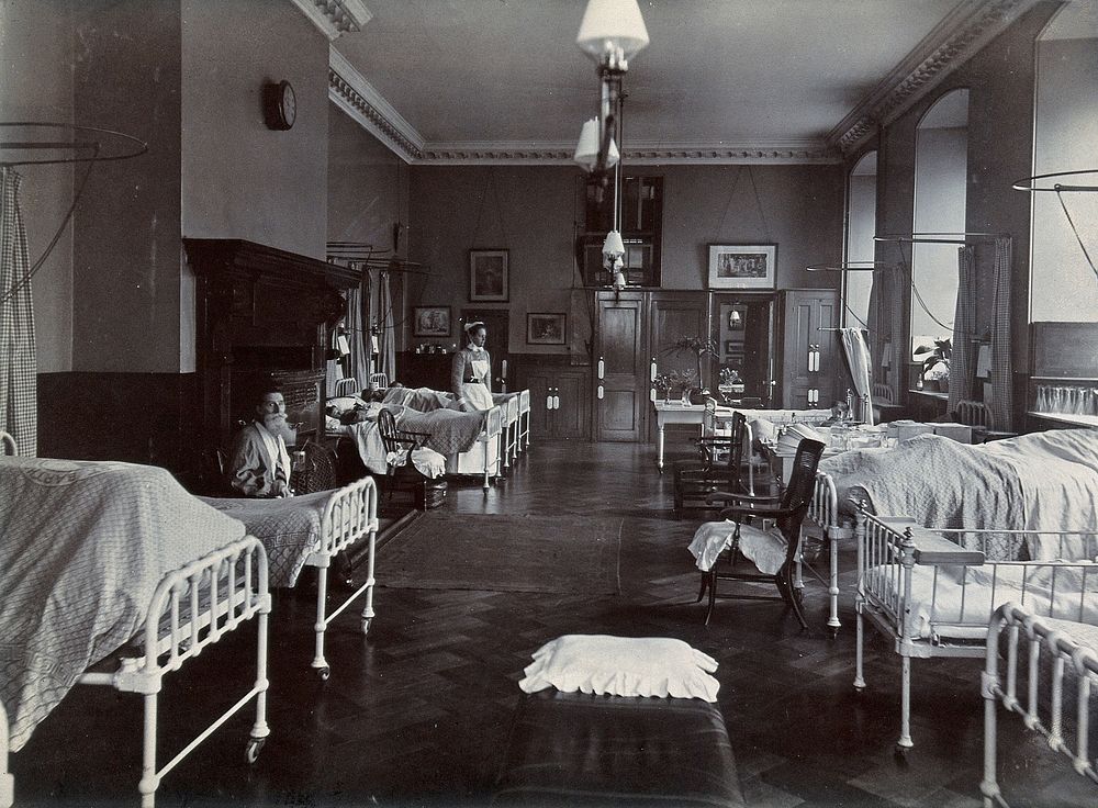 St Bartholomew's Hospital, London: bearded patient and nurse on Pitcairn ward. Photograph, c.1908.