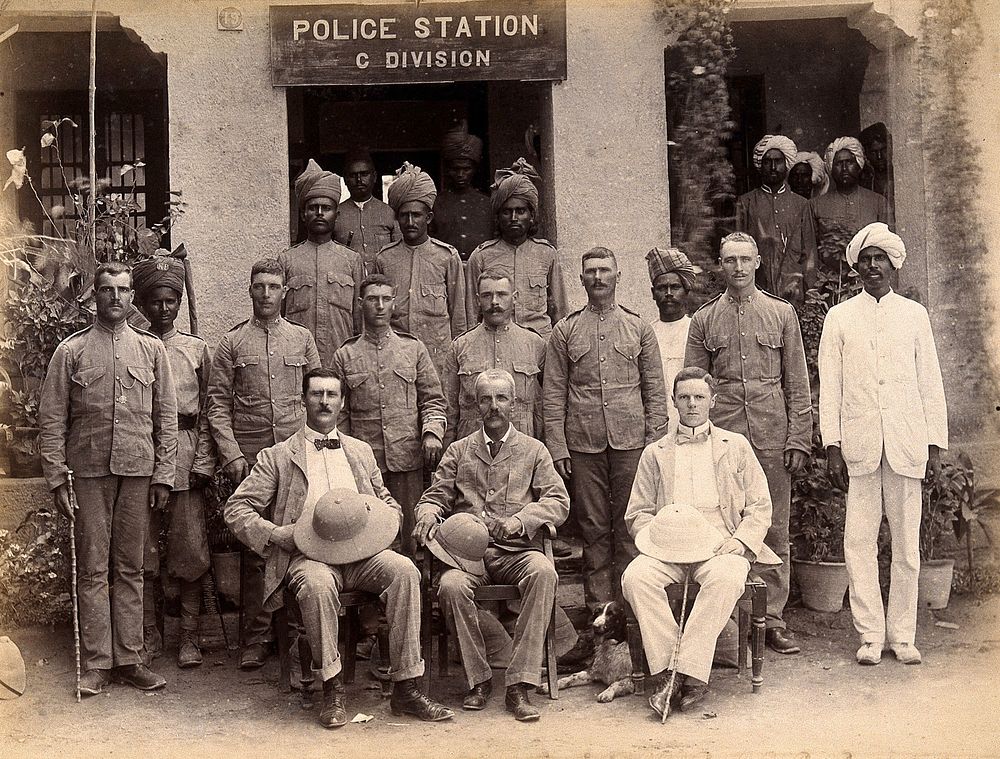 Staff from the Rambagh section of the Karachi Plague Committee, standing outside the police station, India. Photograph, 1897.